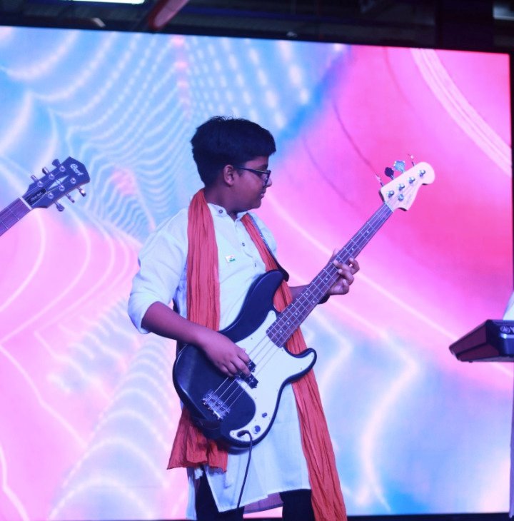 Student performing music on stage