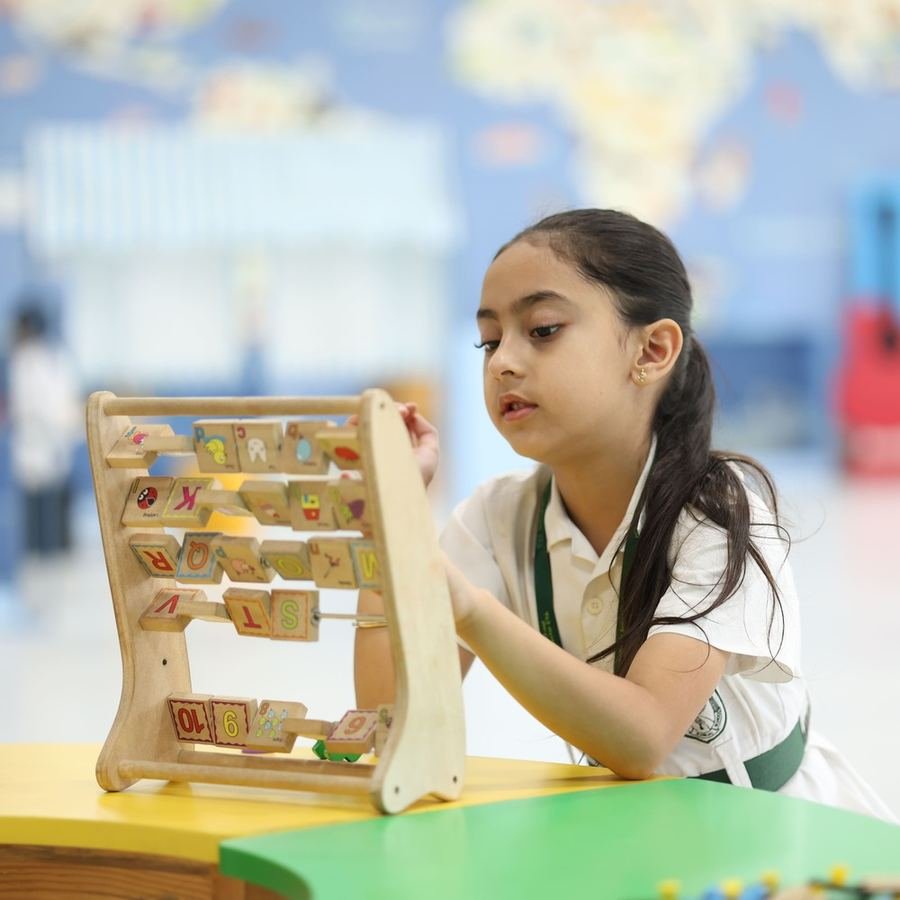Nursery girl counting beads on an abacus