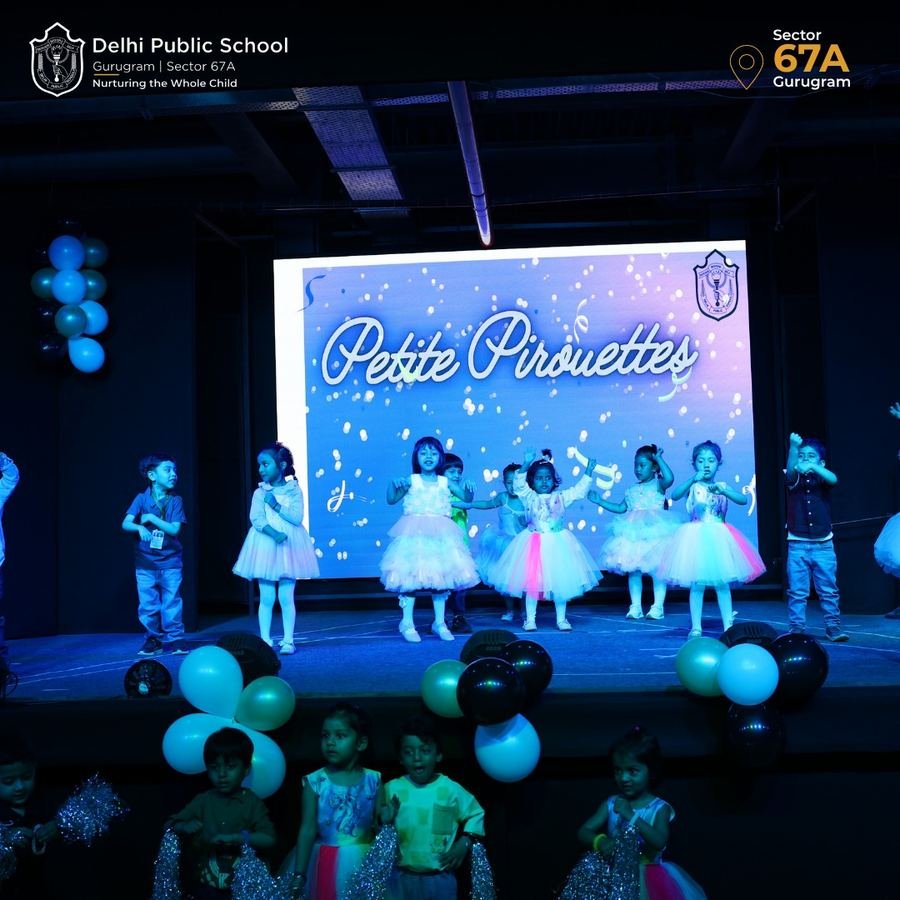 Young children performing a dance on stage at Graduation Day